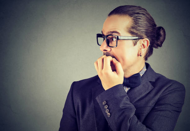 istock anxious young man biting his fingernails looking to the side 962999828