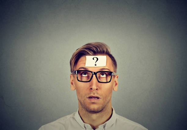 istock thinking man in glasses with question mark looking up 963002162