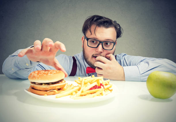 istock Chunky man craving for fast food 963002934