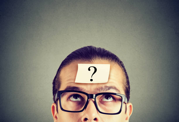 istock thinking man in glasses with question mark looking up 963003570