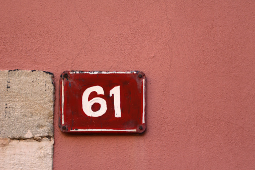 house number 61 on pink facade