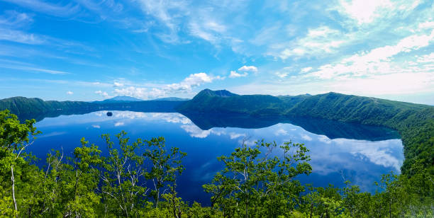 panoramic view of a lake reflecting sky. Lake Mashu,Akan National Park,Japan. panoramic view of a lake reflecting sky. Lake Mashu,Akan National Park,Japan. hokkaido stock pictures, royalty-free photos & images