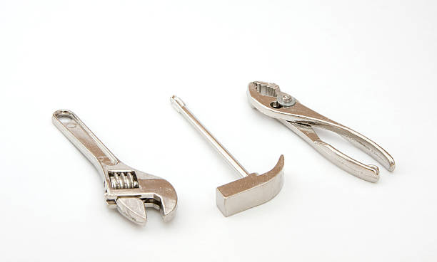 istock Tiny Tools, Miniature Wrench, Hammer, Pliers, Chrome on White Background 96300575