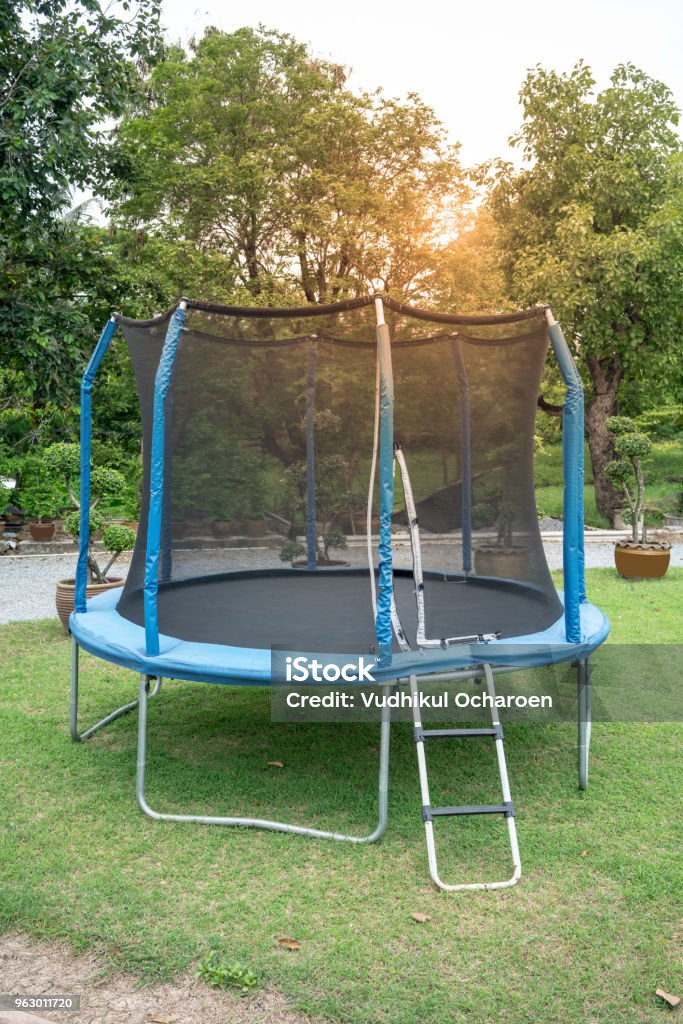 tro Lyrical Bane Blue Big Trampoline On The Green Grass Outdoor Trampoline With Safety Net  With Zipper Entrance Open Jump Trampolining Stock Photo - Download Image  Now - iStock