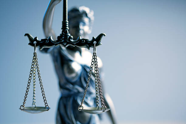 istock Statue Of Lady Justice In Front Blue Background 963011848