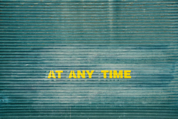 Metal parking garage door with part of warning sign ('no parking at any time') still visible.  Belfast, Northern Ireland.  Cross processed.