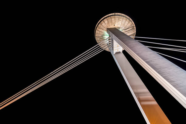 A view of the UFO tower on the Danube bridge by night from below.