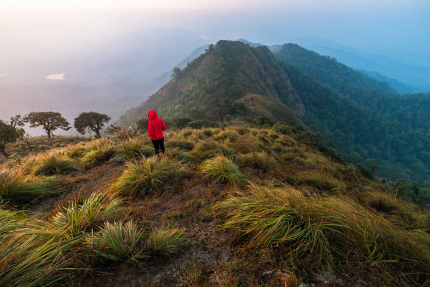 istock High Angle View Of Woman On Mountain Against Sky 963053796