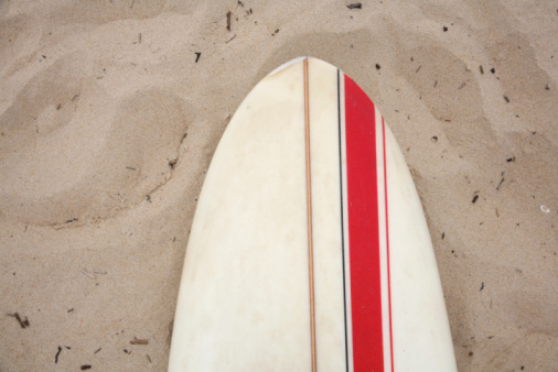 surf board lying in the sand