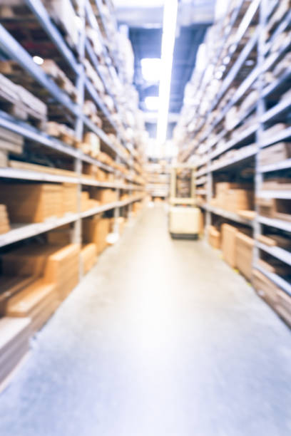 istock Vintage blurred furniture warehouse and auto forklift stacker loader 963061300