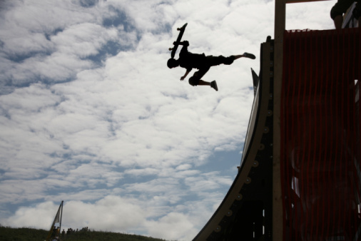 Skater at world championships vert ramp silhouetted against sky