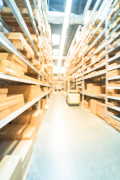 istock Abstract blurred furniture warehouse and auto forklift stacker loader 963067676