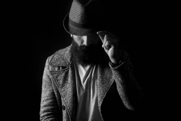 istock hat young man portrait-black background 963072632