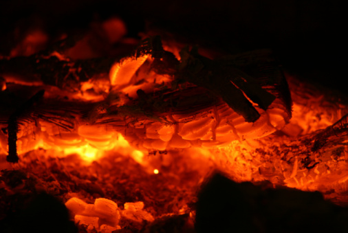 Glow of a log on a fire. Shallow depth of field and soft focus appearance from long exposure glow.