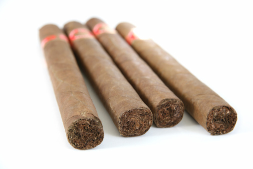 Four Cuban Cigars. Very shallow depth of field. focus only on second cigar edge.