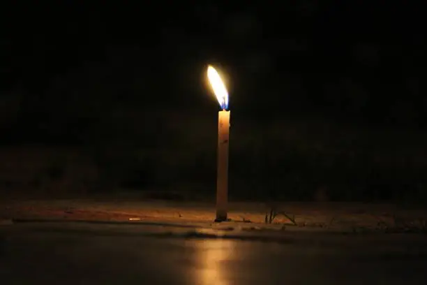 The alone candle in darkness.