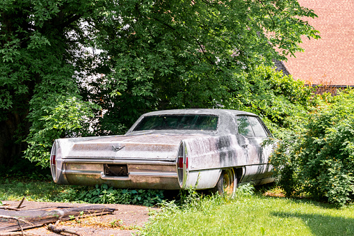 Cairo, IL, United States - May 19, 2018: Abandoned vehicle sitting in a backyard of an abandoned house in Cairo, Illinois.