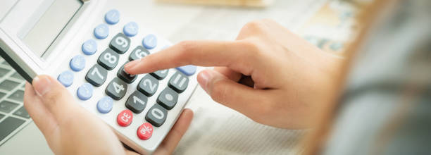 istock Woman accountant or bank worker uses calculator. 963085108
