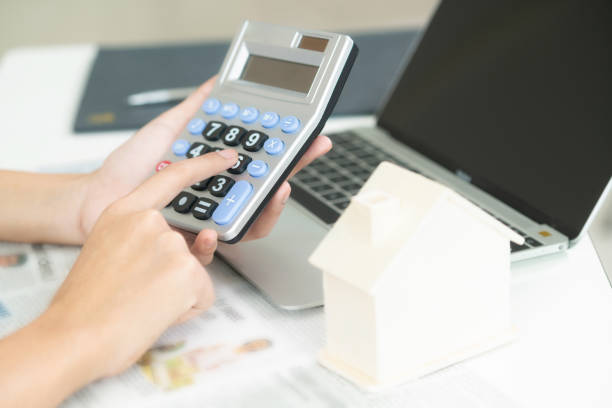 istock Woman accountant or bank worker uses calculator. 963085120