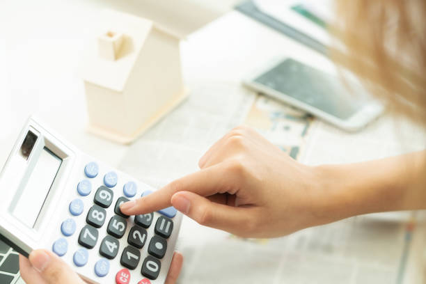 istock Woman accountant or bank worker uses calculator. 963085140