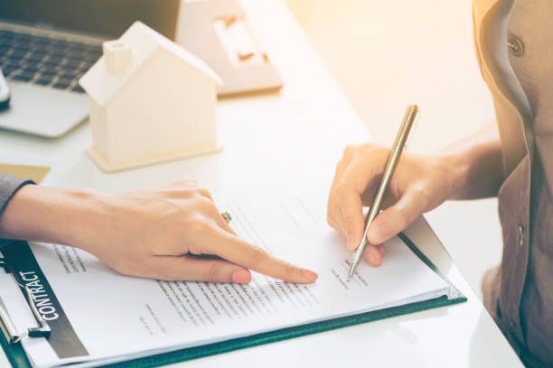 istock Client Signs Document to Buy House and Real Estate 963085142
