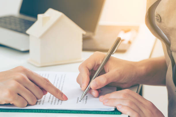 istock Client Signs Document to Buy House and Real Estate 963085164