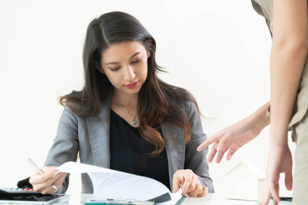 istock Businesswoman reads and talks with partner. 963085176