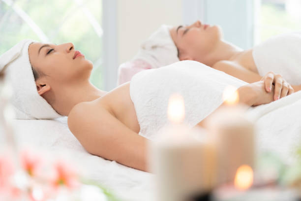 istock Relaxed young woman lying on spa bed for massage. 963087612