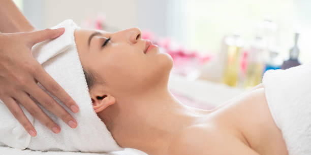 istock Relaxed young woman lying on spa bed for massage. 963087648