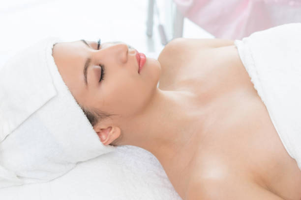 istock Relaxed young woman lying on spa bed for massage. 963087664