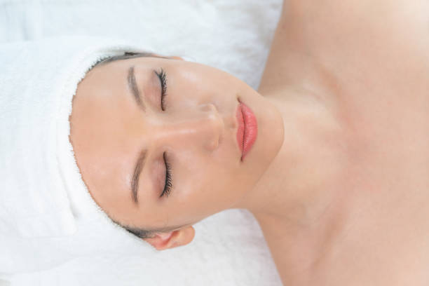 istock Relaxed young woman lying on spa bed for massage. 963087676