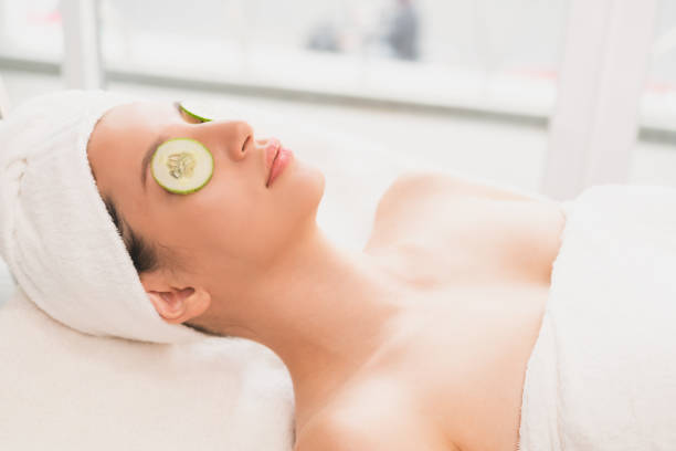 istock Woman getting eye nature treatment by cucumber. 963087688