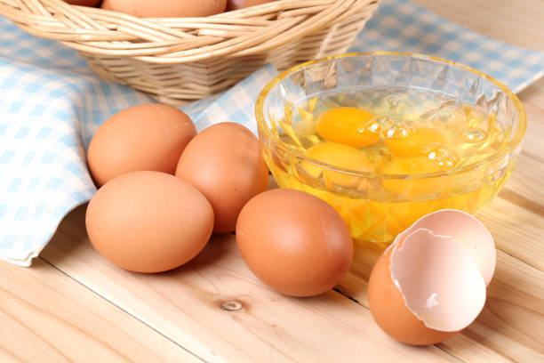istock Group of brown raw eggs on wood background 963089382