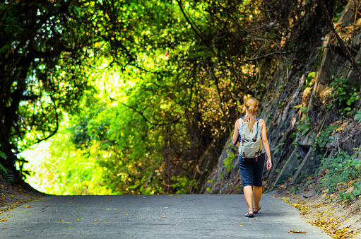 Young woman hiking with backpack.