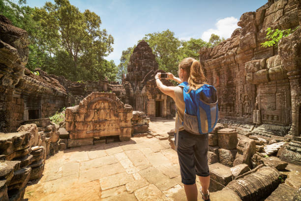 istock Tourist photographing unique bas-relief in Angkor, Cambodia 963092608