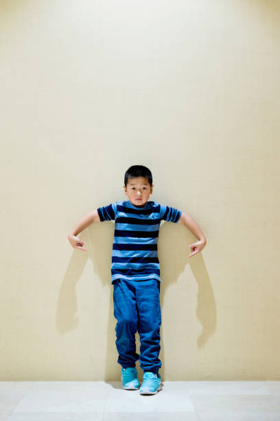 istock Little boy standing by the wall 963093328