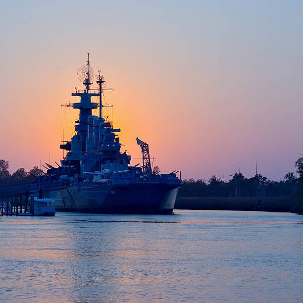 Sunset behind USS North Carolina stock photo