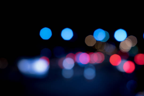 istock Light night at city blue bokeh abstract black background blur lens flare reflection beautiful circle glitter lamp street with dark sky festival 963096232