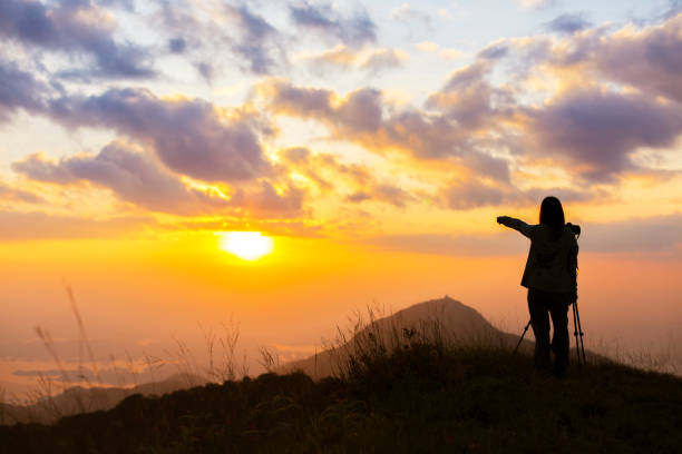 istock Traveller silhouette on the sunset background. 963097166