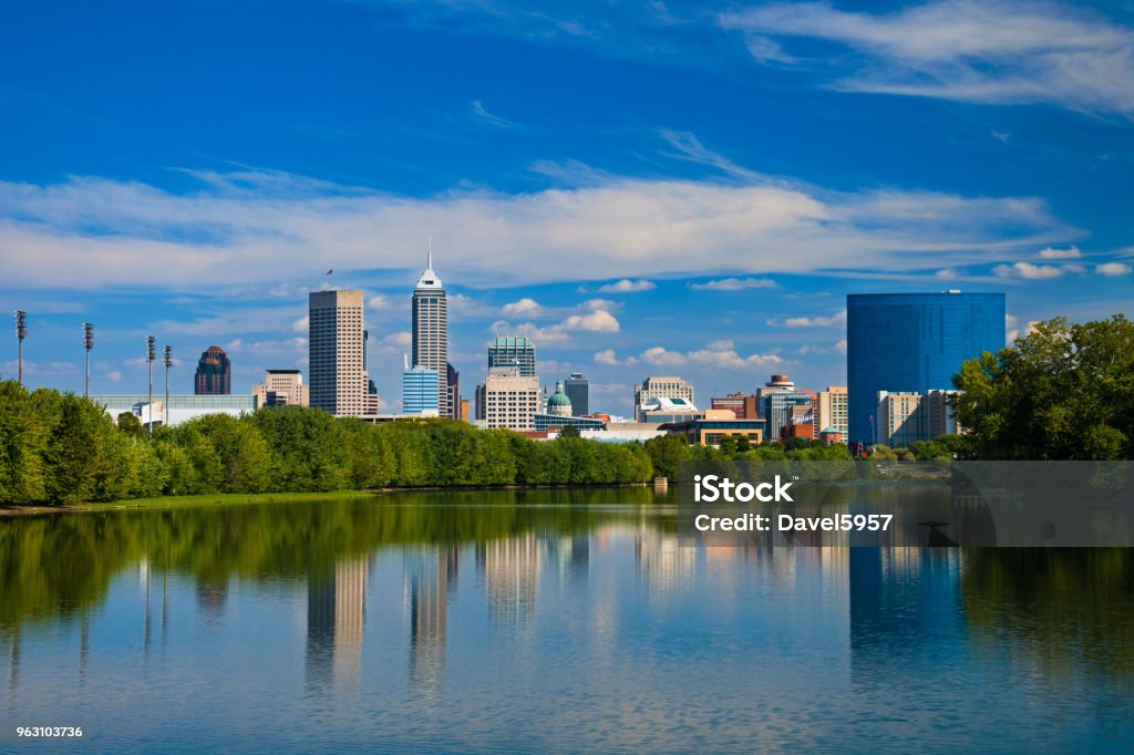 Indianapolis skyline with River Reflections and Blue Sky w/ Clouds Downtown Indianapolis skyline and a blue sky with clouds in the background, and reflections on the White River in the foreground. Indianapolis Stock Photo