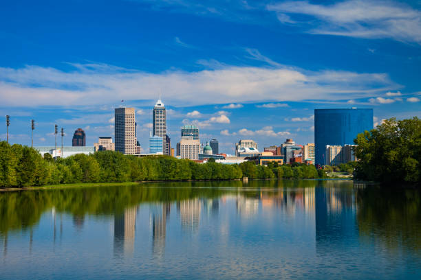 Indianapolis skyline with River Reflections and Blue Sky w/ Clouds Downtown Indianapolis skyline and a blue sky with clouds in the background, and reflections on the White River in the foreground. indianapolis photos stock pictures, royalty-free photos & images