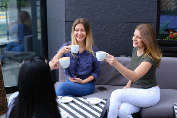 istock Young women drinking coffee at cafe and resting 963103858