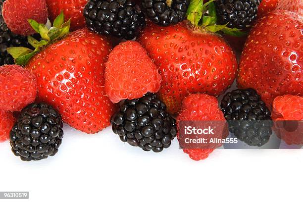 Border Of Mixed Berries Strawberries Raspberries And Blackberries On White Stock Photo - Download Image Now