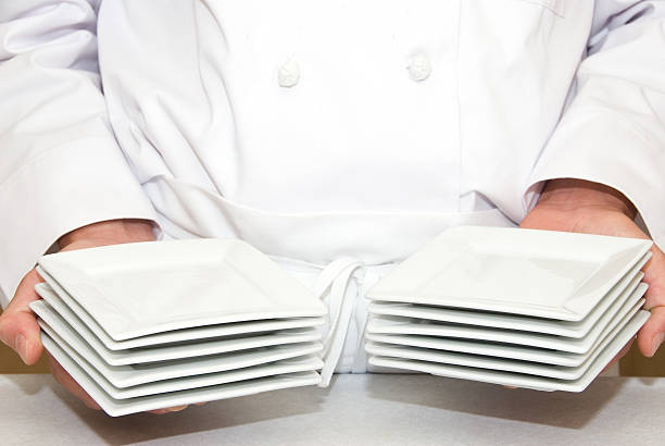 istock Hands with stacks of dessert plates 96310655