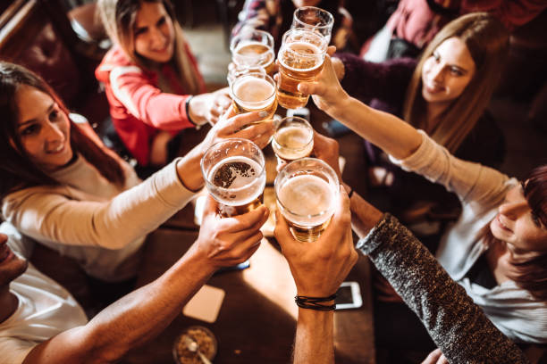 istock people talking toasting in a pub with the beers 963109496