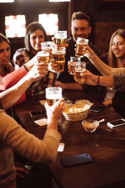 istock people talking toasting in a pub with the beers 963109606