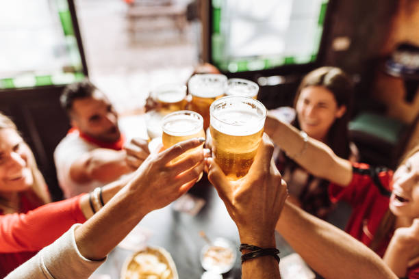 istock people talking toasting in a pub with the beers 963109764