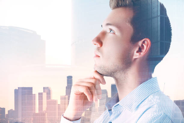 istock Attractive pondering man in city 963110566