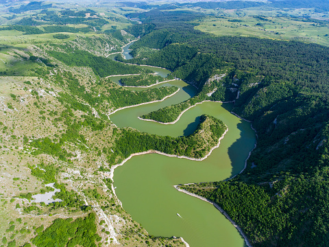 Aerial view of meanders at rocky river Uvac gorge on sunny day, southwest Serbia