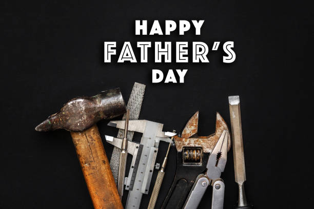 istock happy father's day text sign on working tools hammer wrench pliers calipers screwdriver chisel on black rustic background top view. fathers day greeting card concept. flat lay 963114886